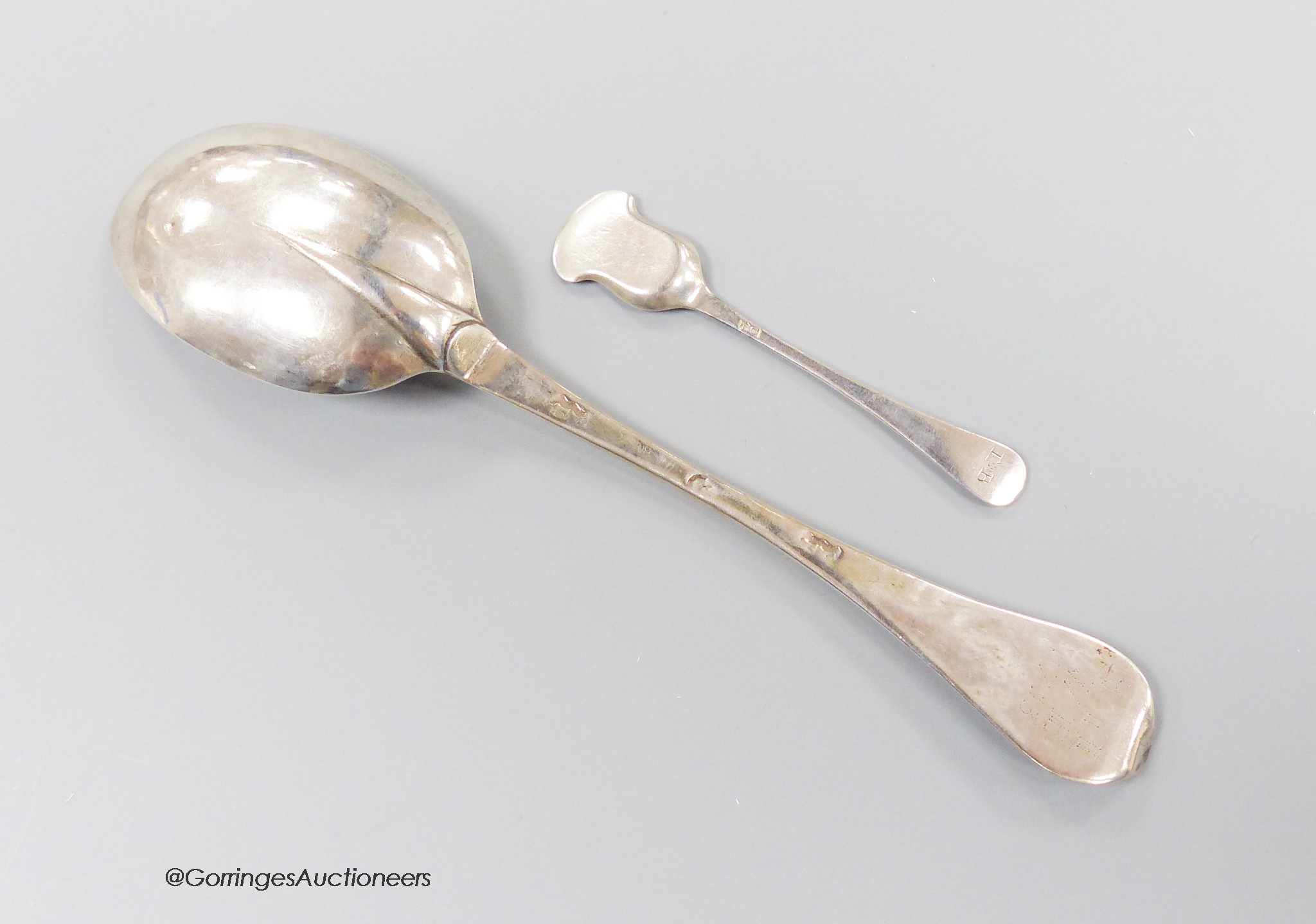 An early 18th century silver dog nose spoon, with engraved prick dot initials with date 1713, indistinct marks, 19.7cm, together with an 18th century Bristol? salt shovel, possibly Ralph Goode, c.1735, gross 46 grams.